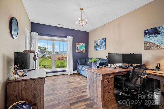 office space featuring visible vents, baseboards, wood finished floors, and a chandelier