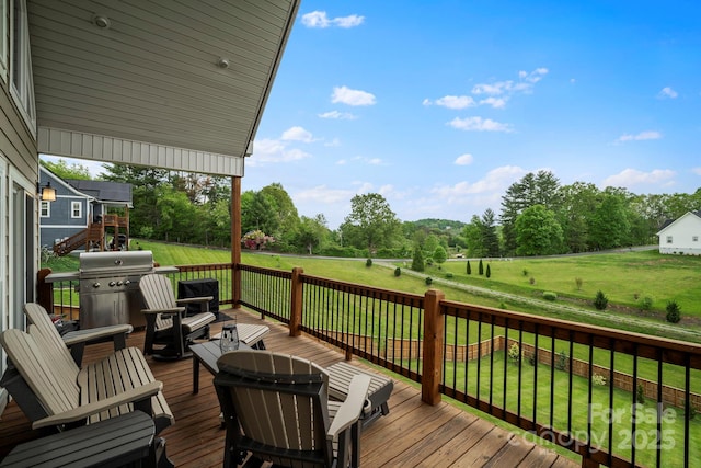 wooden terrace with a lawn and a grill