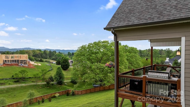 exterior space with a deck with mountain view and fence