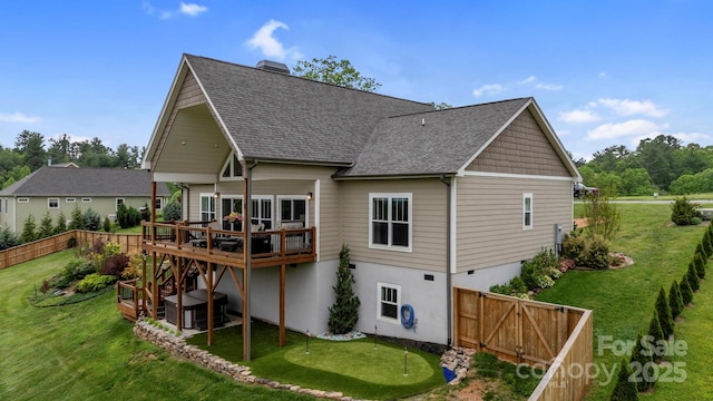 back of house with roof with shingles, a deck, a fenced backyard, cooling unit, and a yard