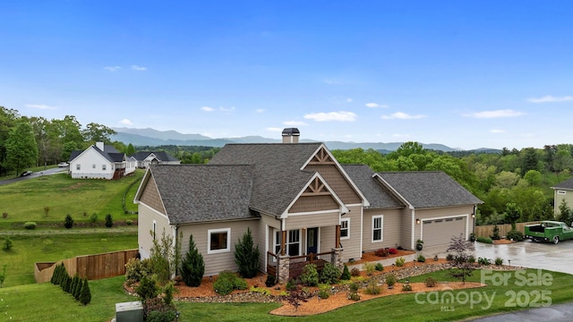 view of front facade featuring fence, driveway, a front yard, and a garage