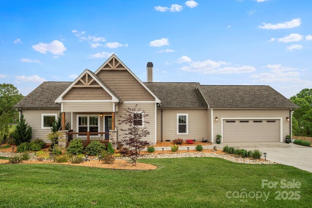 craftsman-style house featuring an attached garage, a front lawn, covered porch, and concrete driveway