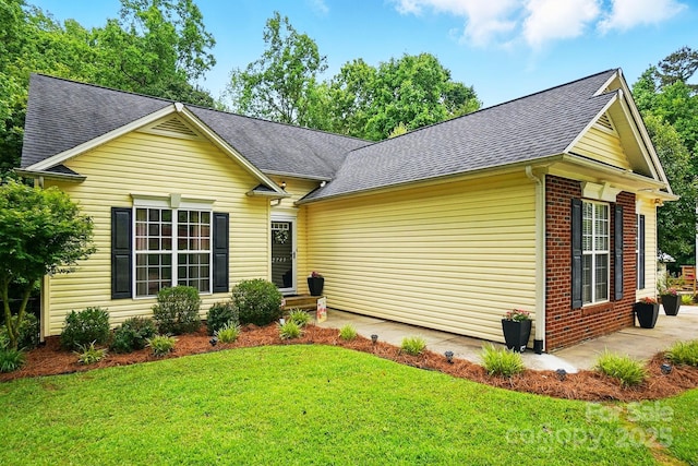 2745 Stockwood Dr, Gastonia, NC 28056 - view of front facade with a shingled roof, a front lawn, brick siding, and a patio area