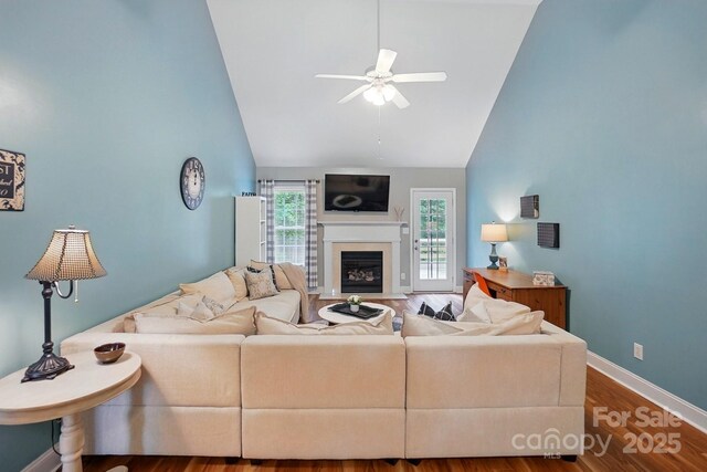 2745 Stockwood Dr, Gastonia, NC 28056 - living area featuring ceiling fan, wood finished floors, a fireplace with flush hearth, baseboards, and high vaulted ceiling
