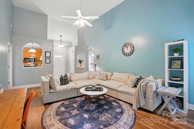 2745 Stockwood Dr, Gastonia, NC 28056 - living room featuring high vaulted ceiling, wood finished floors, ceiling fan, arched walkways, and baseboards