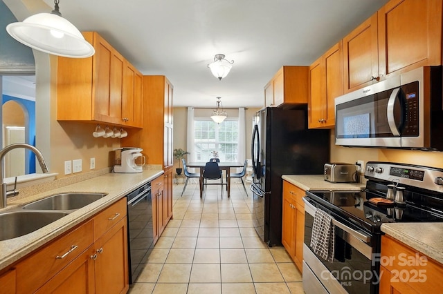 2745 Stockwood Dr, Gastonia, NC 28056 - kitchen featuring stainless steel appliances, a sink, light tile patterned flooring, pendant lighting, and light countertops