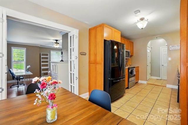 2745 Stockwood Dr, Gastonia, NC 28056 - kitchen featuring stainless steel appliances, arched walkways, ceiling fan, and baseboards
