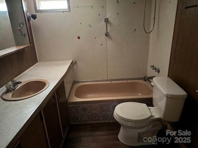 1029 Sullivan St, Wadesboro, NC 28170 - full bathroom with toilet, wood finished floors, vanity, and bathtub / shower combination