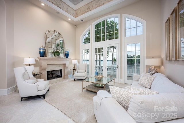 140 Lightship Dr, Mooresville, NC 28117 - living room featuring a towering ceiling, light tile patterned flooring, recessed lighting, baseboards, and a premium fireplace