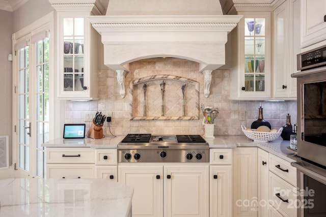 140 Lightship Dr, Mooresville, NC 28117 - kitchen with stainless steel gas stovetop, backsplash, ornamental molding, and light stone counters