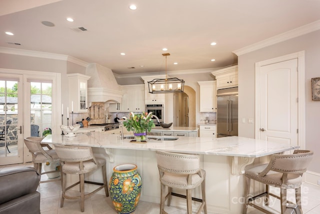 140 Lightship Dr, Mooresville, NC 28117 - kitchen with appliances with stainless steel finishes, premium range hood, a sink, a large island with sink, and tasteful backsplash