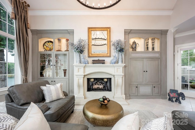 140 Lightship Dr, Mooresville, NC 28117 - living area featuring crown molding, light tile patterned floors, a fireplace with raised hearth, ornate columns, and a chandelier