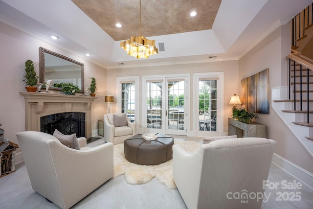 140 Lightship Dr, Mooresville, NC 28117 - living area with a tray ceiling, a chandelier, a fireplace, stairway, and ornamental molding