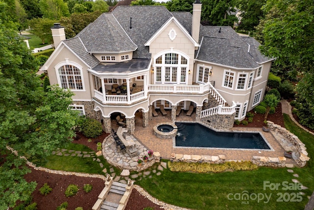 140 Lightship Dr, Mooresville, NC 28117 - rear view of house featuring a chimney, a patio, roof with shingles, and stairway