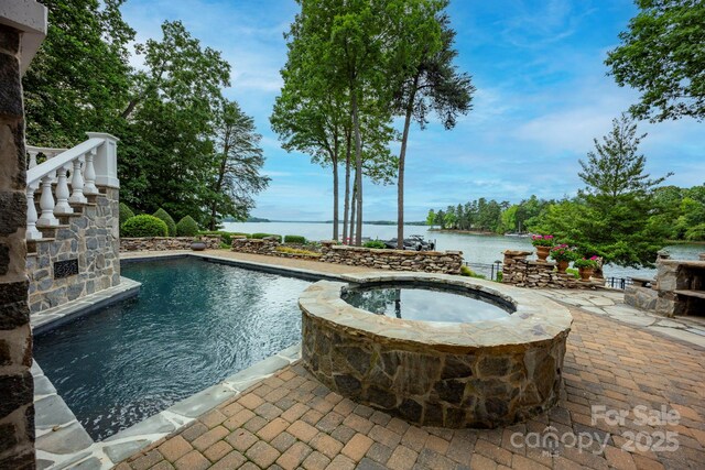140 Lightship Dr, Mooresville, NC 28117 - view of pool with a patio area, a water view, and a pool with connected hot tub