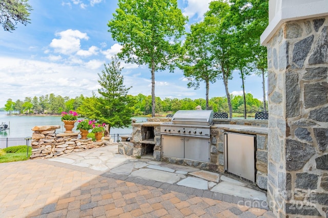 140 Lightship Dr, Mooresville, NC 28117 - view of patio / terrace with exterior kitchen, grilling area, a water view, and fence