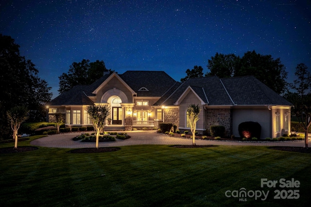 140 Lightship Dr, Mooresville, NC 28117 - french country home with stone siding, a yard, and a porch