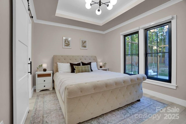 bedroom featuring an inviting chandelier, baseboards, light tile patterned floors, and a raised ceiling