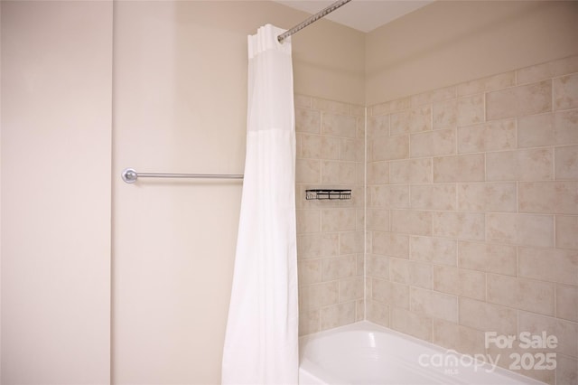 bathroom featuring shower / bathtub combination with curtain