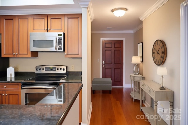 300 W 5th St Unit 404, Charlotte, NC 28202 - kitchen with stainless steel appliances, brown cabinetry, dark wood-style floors, and ornamental molding