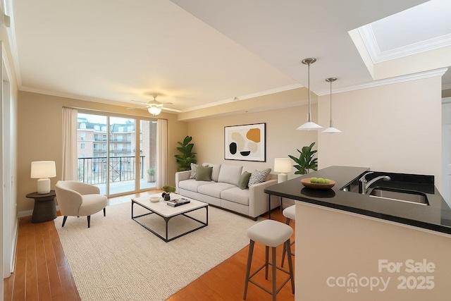 300 W 5th St Unit 404, Charlotte, NC 28202 - living room featuring crown molding, a skylight, wood finished floors, and ceiling fan