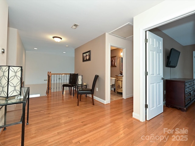 corridor featuring recessed lighting, baseboards, visible vents, and light wood-type flooring