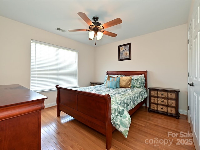 bedroom with visible vents, baseboards, ceiling fan, and light wood-type flooring