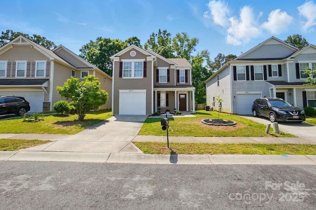 traditional home with an attached garage, a front lawn, and concrete driveway