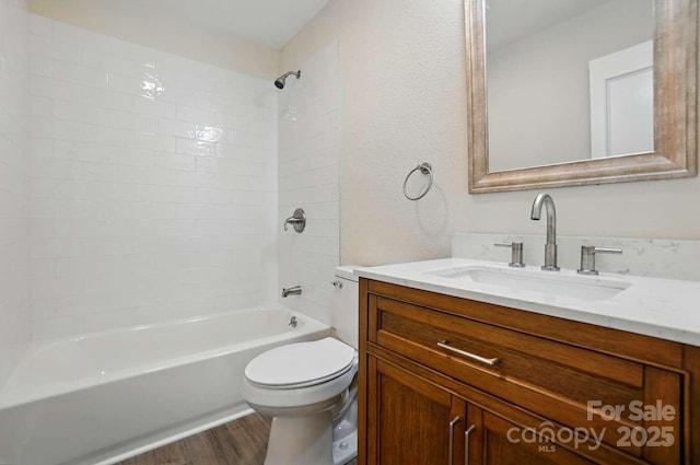 full bath with vanity, shower / bathing tub combination, wood finished floors, and toilet