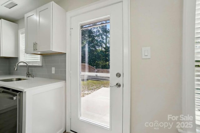 entryway with visible vents and a sink