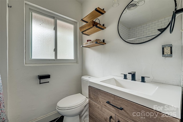 bathroom with toilet, visible vents, and vanity
