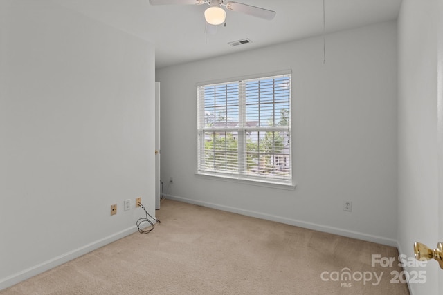 empty room with carpet floors, baseboards, and ceiling fan