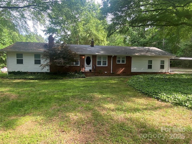 single story home featuring brick siding, a chimney, and a front yard