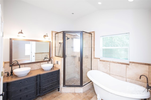 3933 Planters Pl, Indian Trail, NC 28079 - bathroom with tile walls, a freestanding tub, a stall shower, double vanity, and a wainscoted wall