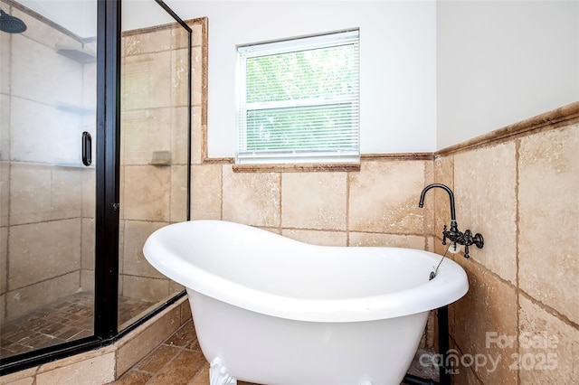 3933 Planters Pl, Indian Trail, NC 28079 - bathroom featuring tile walls, a stall shower, a freestanding tub, and a wainscoted wall