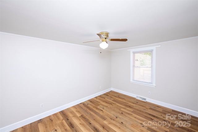 3933 Planters Pl, Indian Trail, NC 28079 - spare room with a ceiling fan, light wood finished floors, and ornamental molding