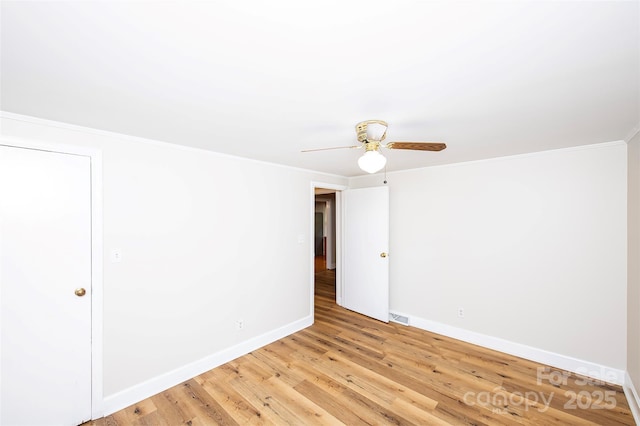 3933 Planters Pl, Indian Trail, NC 28079 - empty room featuring light wood finished floors, ceiling fan, and ornamental molding