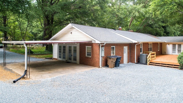 3933 Planters Pl, Indian Trail, NC 28079 - view of front of home with french doors, gravel driveway, an attached carport, and a wooden deck