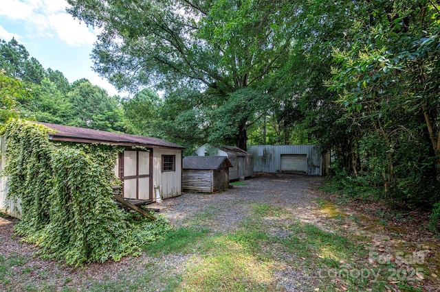 3933 Planters Pl, Indian Trail, NC 28079 - view of yard featuring a storage shed and a detached garage