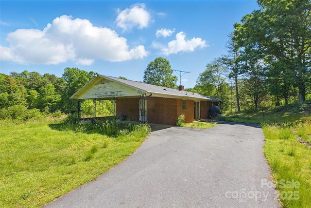 3120 Mineral Springs Mountain Rd, Valdese, NC 28690 - view of front of home featuring asphalt driveway, brick siding, a chimney, and a carport