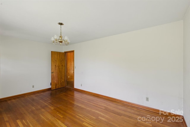 3120 Mineral Springs Mountain Rd, Valdese, NC 28690 - spare room featuring a chandelier, wood finished floors, and baseboards