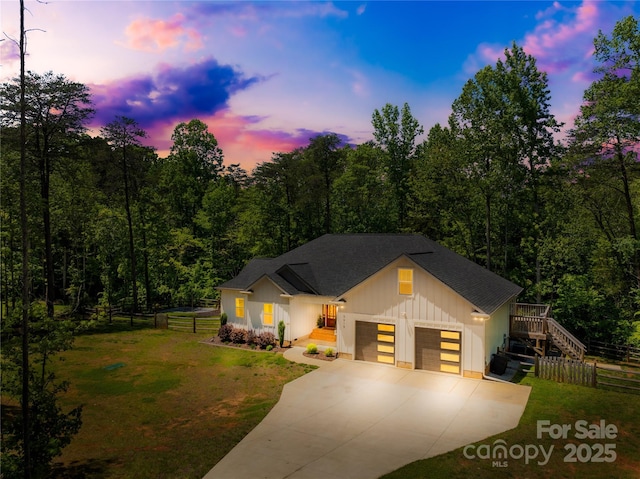 5615 American Way, Denver, NC 28037 - view of front of house with fence, a shingled roof, board and batten siding, a front yard, and concrete driveway