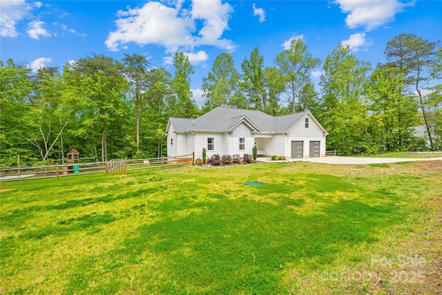 5615 American Way, Denver, NC 28037 - view of front of house with board and batten siding, fence, a front lawn, and a garage