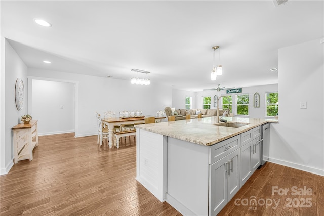 5615 American Way, Denver, NC 28037 - kitchen featuring a ceiling fan, wood finished floors, recessed lighting, light stone counters, and a sink