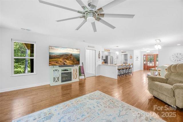 5615 American Way, Denver, NC 28037 - living area with visible vents, a ceiling fan, baseboards, and wood finished floors