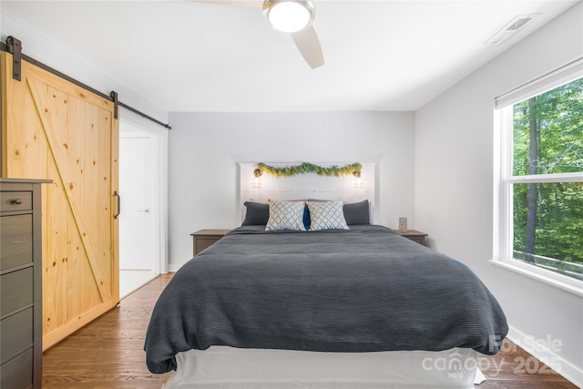 5615 American Way, Denver, NC 28037 - bedroom featuring multiple windows, a barn door, and visible vents