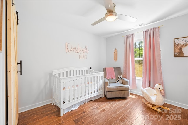 5615 American Way, Denver, NC 28037 - bedroom with visible vents, baseboards, a nursery area, and wood finished floors