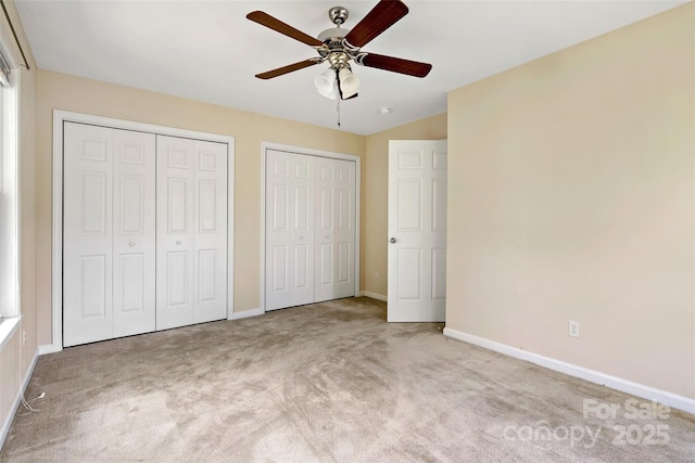 8 Cherry Laurel Ln, Swannanoa, NC 28778 - unfurnished bedroom featuring multiple closets, carpet flooring, baseboards, and ceiling fan