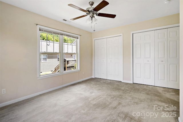 8 Cherry Laurel Ln, Swannanoa, NC 28778 - unfurnished bedroom with two closets, carpet flooring, baseboards, and ceiling fan