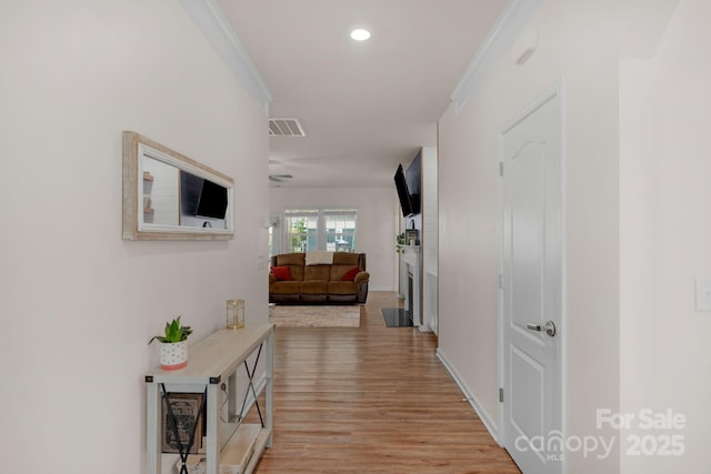 corridor featuring visible vents, recessed lighting, crown molding, and light wood-type flooring